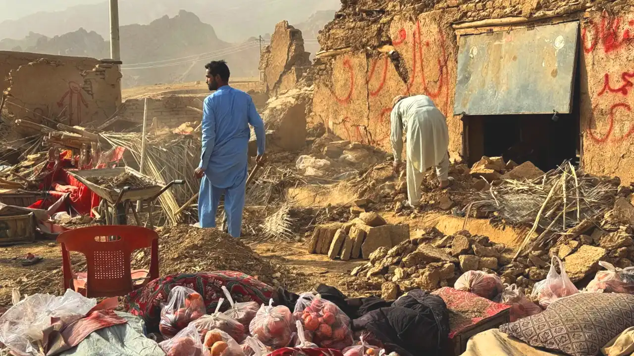 People search through the debris of damaged buildings